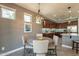 Charming dining area with four chairs and a round table, located next to kitchen at 1342 E Verde Blvd, Queen Creek, AZ 85140