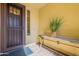 Inviting entryway with a decorative metal security door and a stylish bench at 1342 E Verde Blvd, Queen Creek, AZ 85140