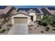 House exterior with solar panels, a two-car garage, and desert landscaping at 1342 E Verde Blvd, Queen Creek, AZ 85140