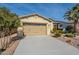 Two-car garage with light-beige doors and landscaping at 1342 E Verde Blvd, Queen Creek, AZ 85140