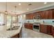 Modern kitchen featuring granite countertops, stainless steel appliances, and ample cabinetry at 1342 E Verde Blvd, Queen Creek, AZ 85140