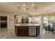 Large kitchen island with granite countertops, double sinks, and a breakfast bar at 1342 E Verde Blvd, Queen Creek, AZ 85140