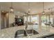 Granite kitchen island with double sinks and seating area, open to Gathering room at 1342 E Verde Blvd, Queen Creek, AZ 85140