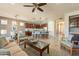 Open concept living room with a ceiling fan, comfortable seating, and views to kitchen at 1342 E Verde Blvd, Queen Creek, AZ 85140