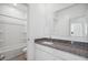 Well-lit bathroom with granite countertop, white cabinetry, and combination shower and tub at 1551 E Mason Dr, Casa Grande, AZ 85122