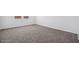 Clean and neutral bedroom featuring soft carpet, white walls, and one window with sunlight at 1551 E Mason Dr, Casa Grande, AZ 85122