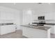 Bright kitchen featuring stainless steel appliances, granite countertops, and white cabinets at 1551 E Mason Dr, Casa Grande, AZ 85122