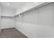 Spacious walk-in closet with shelving and carpet flooring, ready for ample storage at 1551 E Mason Dr, Casa Grande, AZ 85122