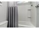 Small bathroom with shower/tub combo and gray curtains at 18865 W Mescal St, Surprise, AZ 85388