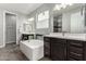 Elegant bathroom with double sinks, soaking tub, and separate shower at 18865 W Mescal St, Surprise, AZ 85388