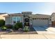 Single-story home with a two-car garage and desert landscaping at 18865 W Mescal St, Surprise, AZ 85388