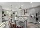 Spacious kitchen with granite island, stainless steel appliances, and gray cabinetry at 18865 W Mescal St, Surprise, AZ 85388