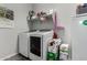 Laundry room with washer, dryer, and shelving at 18865 W Mescal St, Surprise, AZ 85388