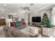 Living room with gray sofas, a Christmas tree, and a view to the kitchen at 18865 W Mescal St, Surprise, AZ 85388