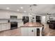 Bright kitchen featuring white cabinets, stainless steel appliances, and a large butcher block island for cooking and entertaining at 19641 E Emperor Blvd, Queen Creek, AZ 85142