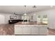 White kitchen island features a butcher block top and pendant lighting, seamlessly flowing into the adjacent living space at 19641 E Emperor Blvd, Queen Creek, AZ 85142