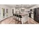 Open kitchen with a butcher block island, barstool seating, and stainless steel appliances, connecting seamlessly to the living area at 19641 E Emperor Blvd, Queen Creek, AZ 85142