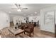 Spacious living area with wood-look flooring, comfortable seating, and a dining table with chairs, perfect for entertaining at 19641 E Emperor Blvd, Queen Creek, AZ 85142