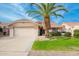 Single-story home with a two-car garage and a lush lawn at 19822 N Zion Dr, Sun City West, AZ 85375