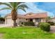 House exterior featuring a palm tree and well-manicured landscaping at 19822 N Zion Dr, Sun City West, AZ 85375