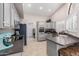 Modern kitchen with gray cabinets, stainless steel appliances, and granite countertops at 19822 N Zion Dr, Sun City West, AZ 85375