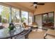 Relaxing sunroom featuring ample seating and backyard access at 19822 N Zion Dr, Sun City West, AZ 85375