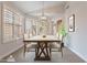 Bright dining room with wood table and chairs, large windows, and plantation shutters at 20449 N 105Th Ave, Peoria, AZ 85382