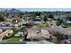 Stunning aerial view of a home with a refreshing pool, lush lawn, palm trees, and mountain views at 2146 E Whitton Ave, Phoenix, AZ 85016