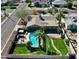 A captivating aerial view showcasing a home with a refreshing pool and lush, green backyard at 2146 E Whitton Ave, Phoenix, AZ 85016