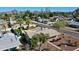 Scenic aerial shot of a home, emphasizing its covered front porch, mature landscaping and neighborhood setting at 2146 E Whitton Ave, Phoenix, AZ 85016