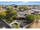 Aerial view of single story home with solar panels, pool, and large backyard at 24444 N 40Th Ln, Glendale, AZ 85310