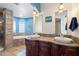 Elegant bathroom with double vanity and a soaking tub at 24444 N 40Th Ln, Glendale, AZ 85310