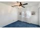 Light and airy bedroom with blue carpet and ceiling fan at 24444 N 40Th Ln, Glendale, AZ 85310