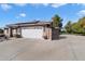 House exterior showcasing a white garage door, solar panels, and a gated driveway at 24444 N 40Th Ln, Glendale, AZ 85310