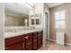 Double vanity bathroom with granite countertop and large mirror at 314 N 79Th Pl, Mesa, AZ 85207