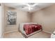 Small bedroom with a twin bed and ceiling fan at 314 N 79Th Pl, Mesa, AZ 85207