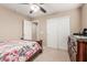 Bedroom with floral bedding and double doors at 314 N 79Th Pl, Mesa, AZ 85207