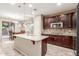 Spacious kitchen featuring granite countertops and dark wood cabinets at 314 N 79Th Pl, Mesa, AZ 85207