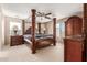 Main bedroom with a large four poster bed and ensuite bathroom at 314 N 79Th Pl, Mesa, AZ 85207