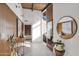 Bright entryway with wood-paneled walls, large mirror, and console table at 4216 N 38Th St # C, Phoenix, AZ 85018