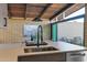 Modern kitchen island with sink and view of dining area at 4216 N 38Th St # C, Phoenix, AZ 85018