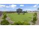 Expansive backyard featuring lush green grass, seating area with modern outdoor furniture, and a neutral-toned fence at 779 S La Mesa Ct, Casa Grande, AZ 85122