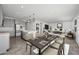 Open-concept kitchen and dining area leading to a living room with modern décor and an island at 779 S La Mesa Ct, Casa Grande, AZ 85122