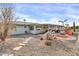 Backyard oasis with a covered patio, fire pit, and desert landscaping at 7960 E Madero Ave, Mesa, AZ 85209