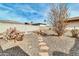 Landscaped backyard with stone pathway, cacti, and desert plants at 7960 E Madero Ave, Mesa, AZ 85209