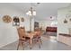 Cozy dining area with a wooden table and chairs, adjacent to the living room at 7960 E Madero Ave, Mesa, AZ 85209