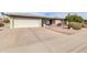 Front view of a single story home with a long driveway at 7960 E Madero Ave, Mesa, AZ 85209