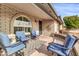 Brick front porch with seating area, offering a relaxing outdoor space at 7960 E Madero Ave, Mesa, AZ 85209