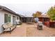 Backyard with a patio seating, chicken coop, grill, trampoline, and mature landscaping at 813 E Glendale Ave, Phoenix, AZ 85020