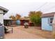 Backyard with shed, chicken coop, mature landscaping, and patio with seating at 813 E Glendale Ave, Phoenix, AZ 85020